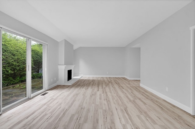 170 Heritage Vlg Unit B, Southbury, CT 06488 - unfurnished living room featuring light wood finished floors, a fireplace, baseboards, and lofted ceiling