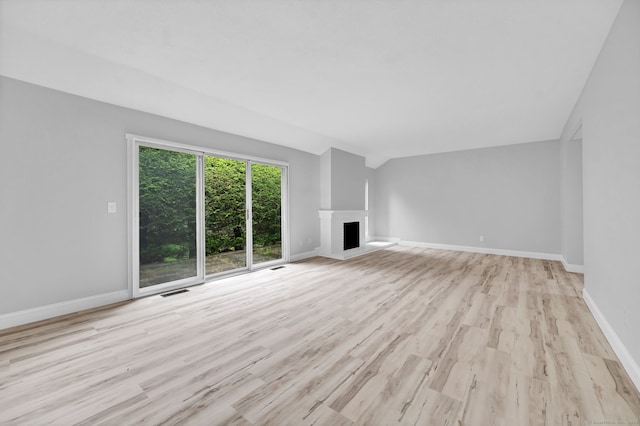 170 Heritage Vlg Unit B, Southbury, CT 06488 - unfurnished living room featuring wood finished floors, baseboards, and a fireplace with raised hearth