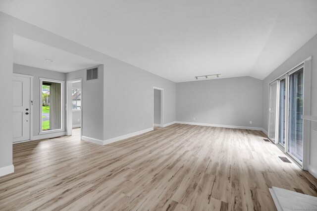 170 Heritage Vlg Unit B, Southbury, CT 06488 - unfurnished living room featuring light wood-style flooring, baseboards, and vaulted ceiling