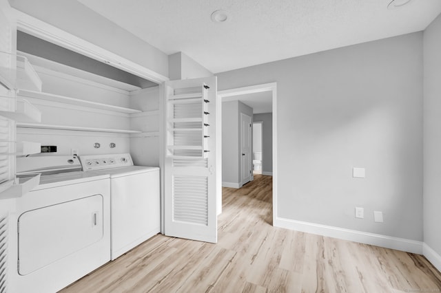 170 Heritage Vlg Unit B, Southbury, CT 06488 - laundry area with washer and clothes dryer, light wood finished floors, and baseboards