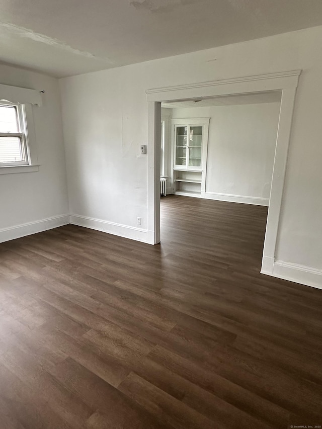 47 Holl St, Manchester, CT 06040 - unfurnished room featuring dark wood-style floors, baseboards, and radiator