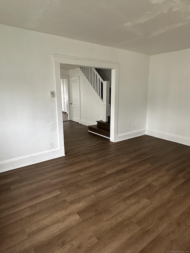 47 Holl St, Manchester, CT 06040 - unfurnished room with stairs, dark wood finished floors, and baseboards