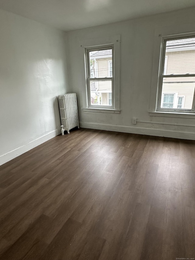 47 Holl St, Manchester, CT 06040 - unfurnished room featuring radiator, dark wood-type flooring, and baseboards