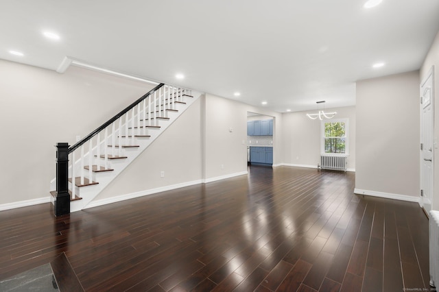 56 Uncas Ave, New London, CT 06320 - unfurnished living room featuring radiator, stairway, baseboards, a chandelier, and dark wood finished floors