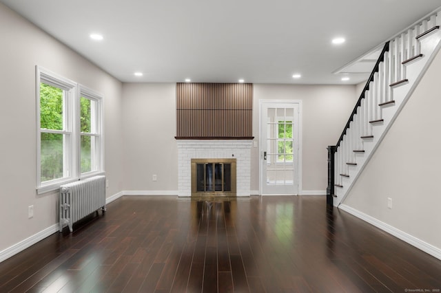 56 Uncas Ave, New London, CT 06320 - unfurnished living room featuring radiator heating unit, baseboards, stairway, wood finished floors, and recessed lighting