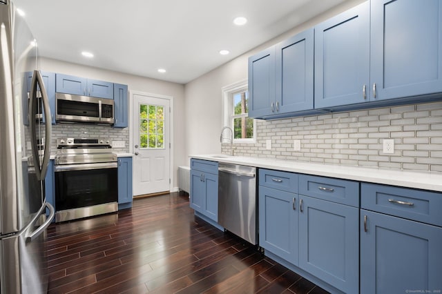 56 Uncas Ave, New London, CT 06320 - kitchen featuring appliances with stainless steel finishes, blue cabinets, a sink, dark wood-type flooring, and recessed lighting