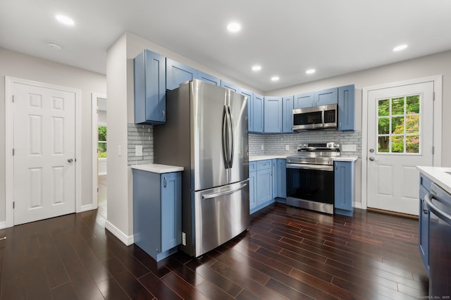 56 Uncas Ave, New London, CT 06320 - kitchen featuring stainless steel appliances, blue cabinetry, light countertops, decorative backsplash, and recessed lighting