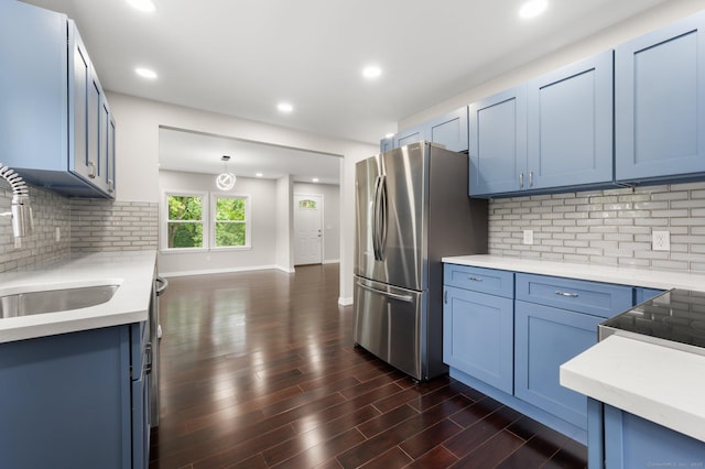 56 Uncas Ave, New London, CT 06320 - kitchen featuring blue cabinets, freestanding refrigerator, a sink, tasteful backsplash, and dark wood-type flooring