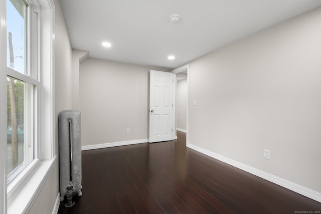 56 Uncas Ave, New London, CT 06320 - empty room featuring dark wood-style flooring, a smoke detector, baseboards, recessed lighting, and radiator