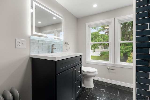 56 Uncas Ave, New London, CT 06320 - bathroom with vanity, toilet, marble look tile flooring, baseboards, and recessed lighting