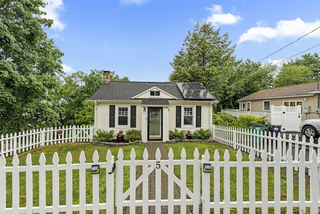5 Glenville Rd, New Fairfield, CT 06812 - view of front of home with a chimney, a gate, a fenced front yard, and roof mounted solar panels