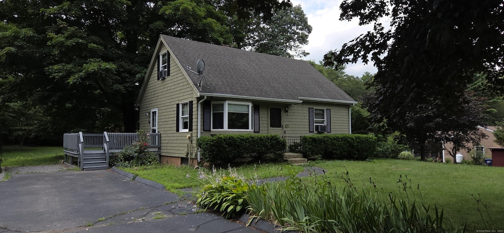 17 Hemlock Dr, Plainfield, CT 06374 - view of front of property with a deck, a shingled roof, a front yard, and cooling unit