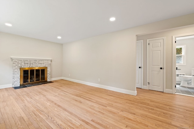 1357 Slater Rd, New Britain, CT 06053 - unfurnished living room with light wood-type flooring, baseboards, recessed lighting, and a fireplace