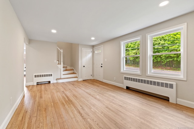 1357 Slater Rd, New Britain, CT 06053 - foyer entrance featuring radiator heating unit, light wood-style flooring, baseboards, stairway, and recessed lighting