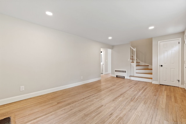 1357 Slater Rd, New Britain, CT 06053 - unfurnished living room featuring radiator heating unit, light wood-style floors, stairs, baseboards, and recessed lighting