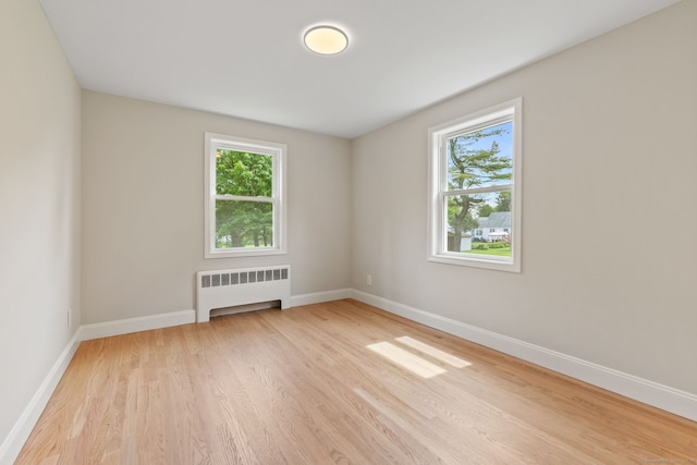1357 Slater Rd, New Britain, CT 06053 - unfurnished room with radiator, plenty of natural light, light wood finished floors, and baseboards