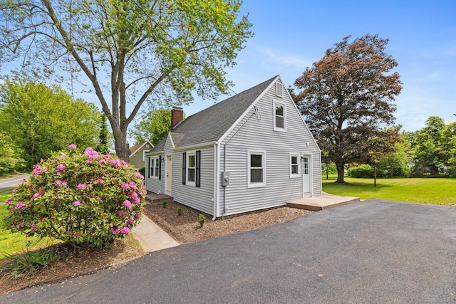 1357 Slater Rd, New Britain, CT 06053 - view of home's exterior with a chimney, a shingled roof, and a yard
