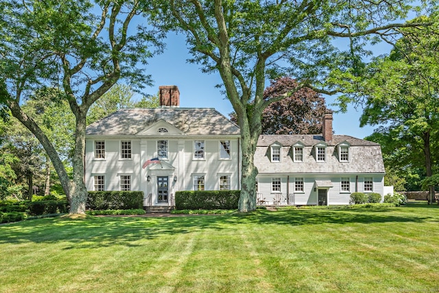 264 Taugwonk Rd, Stonington, CT 06378 - view of front facade featuring a chimney, a front yard, and entry steps