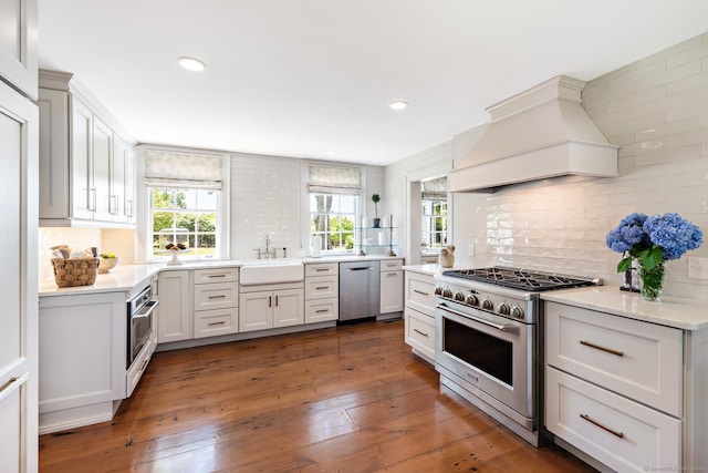 264 Taugwonk Rd, Stonington, CT 06378 - kitchen featuring stainless steel appliances, premium range hood, decorative backsplash, light countertops, and recessed lighting