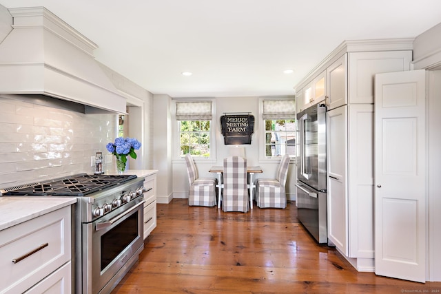 264 Taugwonk Rd, Stonington, CT 06378 - kitchen with high end appliances, custom exhaust hood, backsplash, white cabinetry, and recessed lighting