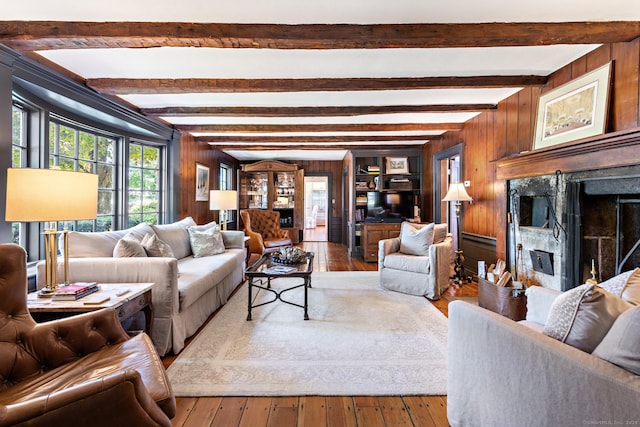 264 Taugwonk Rd, Stonington, CT 06378 - living room with wooden walls, hardwood / wood-style floors, a fireplace, and beamed ceiling