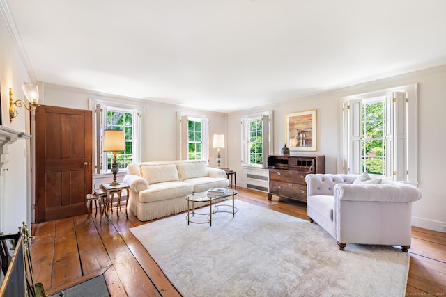 264 Taugwonk Rd, Stonington, CT 06378 - living room featuring plenty of natural light, light wood-style floors, and ornamental molding