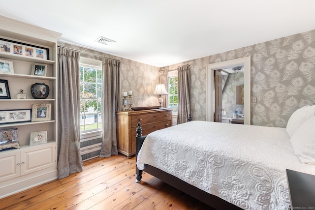 264 Taugwonk Rd, Stonington, CT 06378 - bedroom featuring wallpapered walls and light wood-style flooring