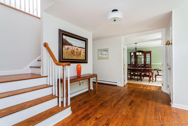 12 Fawn Ridge Dr, Brookfield, CT 06804 - hallway featuring baseboard heating, stairs, wood finished floors, and a chandelier