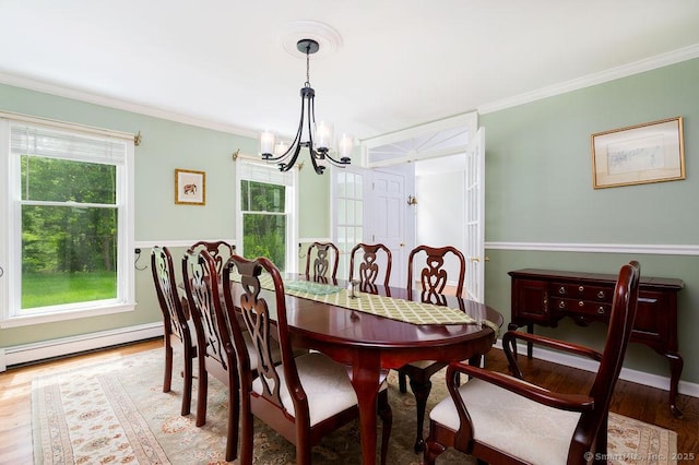 12 Fawn Ridge Dr, Brookfield, CT 06804 - dining space with a baseboard heating unit, a chandelier, wood finished floors, and ornamental molding