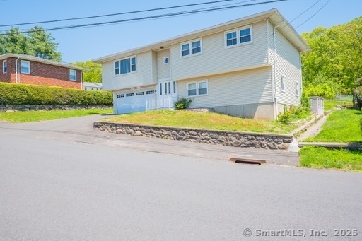 188 Judith Ln, Waterbury, CT 06704 - view of front facade with driveway and a garage