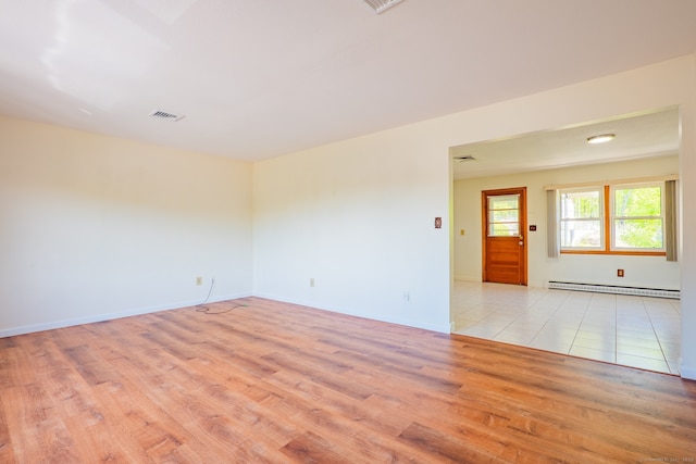 188 Judith Ln, Waterbury, CT 06704 - spare room with baseboard heating, light wood finished floors, and baseboards