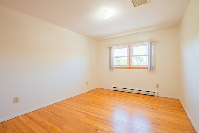 188 Judith Ln, Waterbury, CT 06704 - spare room featuring a baseboard heating unit, wood finished floors, and baseboards