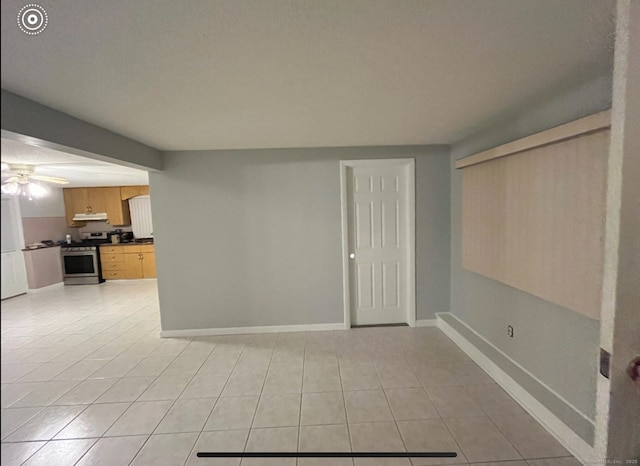 188 Judith Ln, Waterbury, CT 06704 - unfurnished living room with light tile patterned floors, baseboards, and a ceiling fan
