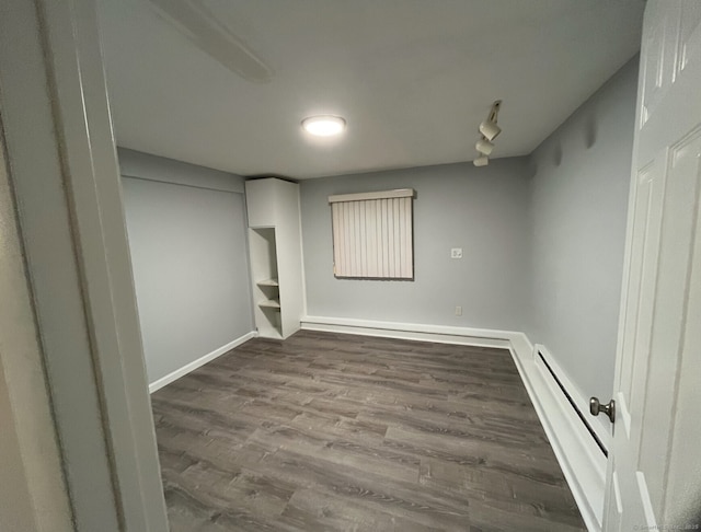 188 Judith Ln, Waterbury, CT 06704 - empty room with wood finished floors, baseboards, and a baseboard radiator