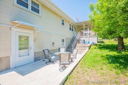 188 Judith Ln, Waterbury, CT 06704 - back of house with stairway, a yard, and a patio