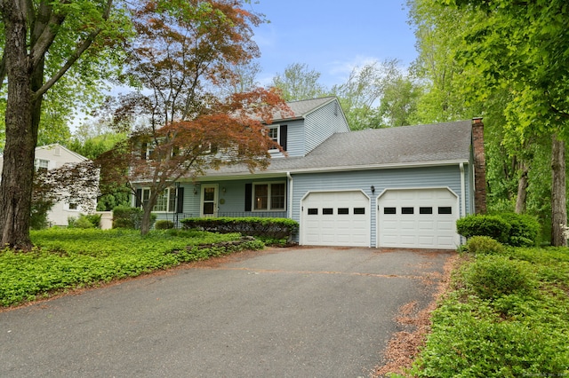 80 Farmstead Ln, Windsor, CT 06095 - traditional home with a garage, asphalt driveway, a chimney, a porch, and a shingled roof