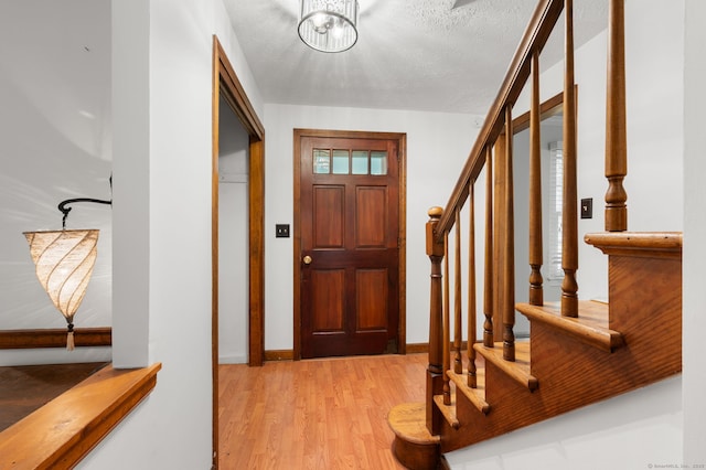 80 Farmstead Ln, Windsor, CT 06095 - foyer with light wood-style floors, stairway, and a textured ceiling