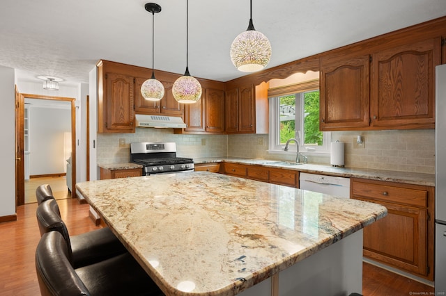 80 Farmstead Ln, Windsor, CT 06095 - kitchen with gas stove, under cabinet range hood, a sink, dishwasher, and backsplash