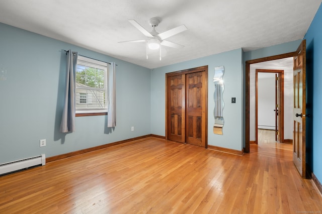 80 Farmstead Ln, Windsor, CT 06095 - unfurnished bedroom with light wood-type flooring, a baseboard heating unit, a baseboard radiator, a closet, and baseboards