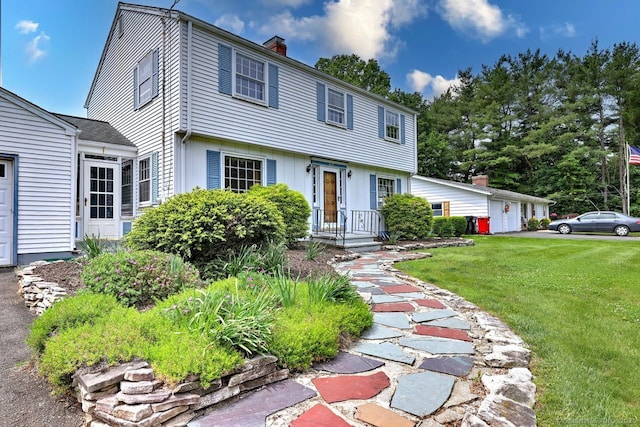 423 Baldwin Ave, Meriden, CT 06450 - colonial house with a chimney, a front yard, and a detached garage