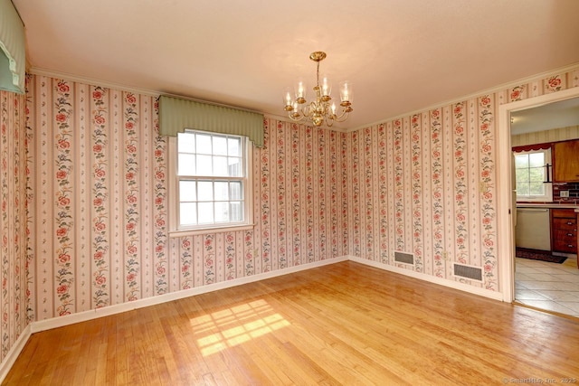 423 Baldwin Ave, Meriden, CT 06450 - unfurnished room featuring a chandelier, wood finished floors, ornamental molding, and baseboards