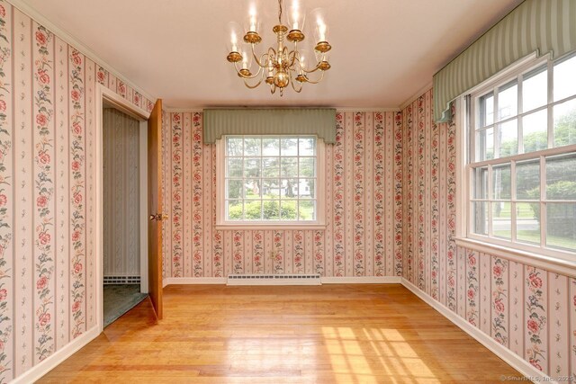 423 Baldwin Ave, Meriden, CT 06450 - unfurnished dining area with light wood-style floors, a baseboard heating unit, a chandelier, and plenty of natural light