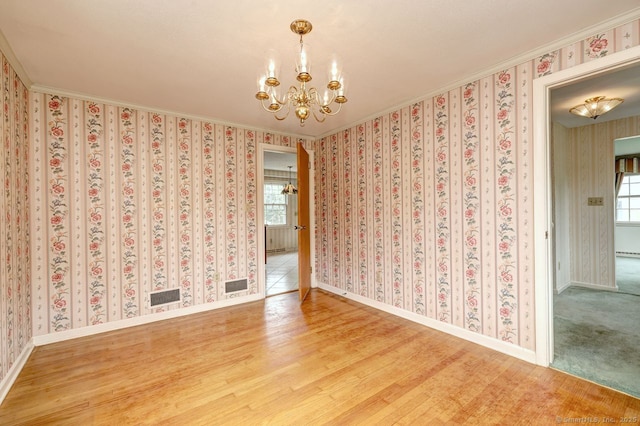 423 Baldwin Ave, Meriden, CT 06450 - spare room featuring a chandelier, ornamental molding, wood finished floors, and baseboards