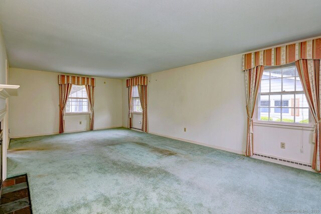 423 Baldwin Ave, Meriden, CT 06450 - unfurnished living room featuring baseboard heating, a glass covered fireplace, carpet, and baseboards