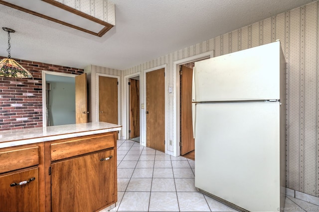 423 Baldwin Ave, Meriden, CT 06450 - kitchen with freestanding refrigerator, wallpapered walls, light countertops, brown cabinetry, and a textured ceiling