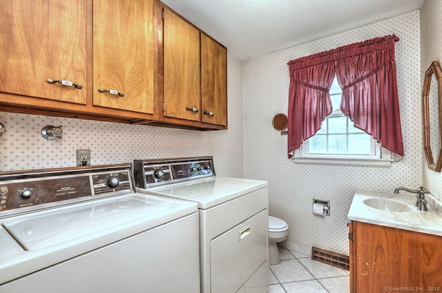 423 Baldwin Ave, Meriden, CT 06450 - laundry room featuring wallpapered walls, washing machine and clothes dryer, light tile patterned floors, and a textured ceiling