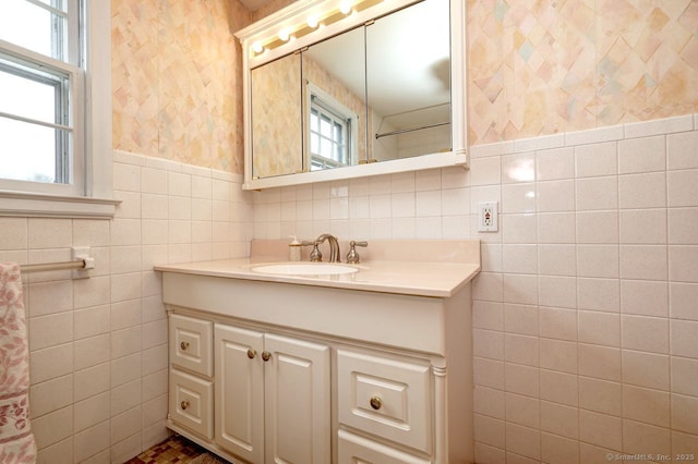 423 Baldwin Ave, Meriden, CT 06450 - bathroom with wallpapered walls, vanity, tile walls, and wainscoting