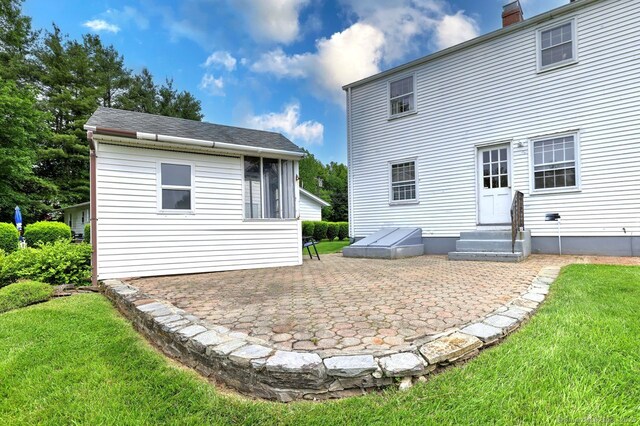 423 Baldwin Ave, Meriden, CT 06450 - rear view of house with entry steps, a patio area, a lawn, and a chimney
