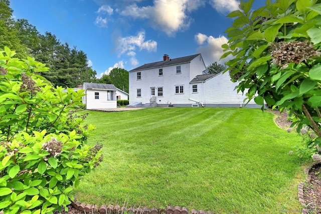 423 Baldwin Ave, Meriden, CT 06450 - back of property with a lawn, a chimney, and an outbuilding