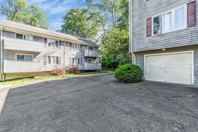 520 Vincellette St Unit C1, Bridgeport, CT 06606 - view of building exterior featuring a garage and asphalt driveway